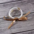 All-weather set of five silver glitter jelly bangles decorated with a bronze silk ribbon - 5 Piece Set / Champagne Gold