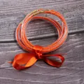 Stylish set of 5 orange silicone jelly bangles with inner seed beads and silk ribbon bow - 5 Pieces / Orange