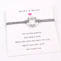Close-up of gray wax cord wish bracelet with engraved Hope ring on display card - Gray
