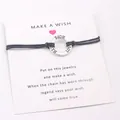 Detailed view of Faith Hope Love engraved silver ring on navy blue cord bracelet - Black