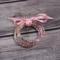 Set of 5 silicone bangles filled with colorful seed beads and a pink ribbon bow - 5 Pieces / Mixed Light Pink