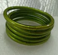 Stack of vibrant fluorescent green PVC silicone jelly bangles with a metallic sheen - Light Green