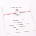 Detailed macro view of pink wax cord wish bracelet with engraved Hope Faith Love silver ring - Pink