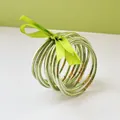 Detailed view of nine green glitter jelly bangles tied with a lime green ribbon. - 9 Pieces Set / Matcha Green