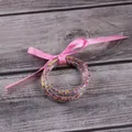 Set of 5 clear jelly bangles filled with colorful seed beads and tied with a pink ribbon bow - 5 Pieces / Mixed Dark Pink