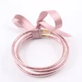 Ensemble de trois bracelets jonc en silicone rose pailleté avec un nœud en satin. - Ensemble à 3 couches / Rose