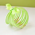 Stack of 9 vibrant lime green glitter jelly bangles tied with a matching satin ribbon bow - 9 Pieces Set / Light Green
