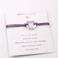 Detail shot of purple wax cord bracelet with engraved silver FAITH HOPE LOVE ring. - Purple