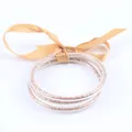 Lot de 3 bracelets jonc en silicone à paillettes dorées avec un nœud en ruban satiné - Ensemble à 3 couches / Or champagne