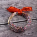 5-piece set of jelly silicone bangles with colorful seed beads and bright orange ribbon bow - 5 Pieces / Mixed Orange