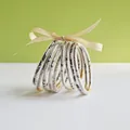 Macro view of 9-piece jelly bangle set with snake print patterns and gold accents. - 9 Pieces Set / Snake Print