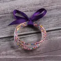 Set of 5 clear silicone bangles featuring colorful seed beads and a purple ribbon bow - 5 Pieces / Mixed Beads Purple