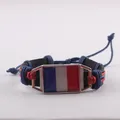 Handcrafted woven leather bracelet with French flag metal emblem on a white background. - France Style