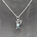 Detailed macro view of vintage stamped letter P pendant featuring a turquoise stone. - Letter P