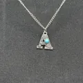 Detailed view of vintage silver initial A necklace with turquoise and engravings. - Letter A