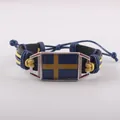 Retro handmade leather bracelet featuring the Swedish flag with braided wax cord accents - Sweden