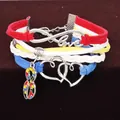 Nahaufnahme des mehrsträngigen geflochtenen Autismus-Armbands mit silbernen Anhängern. - Mehrlagiges Gewebtes Herz Puzzle Armband / Hellrosa