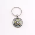 Macro view of a Norse Viking Vegvisir compass time gem glass cabochon pendant keychain - Vintage Viking Rune Compass / Silver