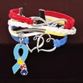 Close-up of multi-layer autism awareness bracelet with heart and ribbon charms - Multi-layer Woven Heart Puzzle Bracelet / Black