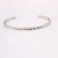 Detail of silver stainless steel cuff bracelet with Teachers Change the World engraving - Teachers Change the World Engraved Style / Silver