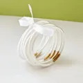 Set of nine white glitter jelly bangles with gold thread, tied with a ribbon. - 9 Pieces Set / White