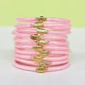 Set di 10 bracciali jelly rosa glitterati con fibbie a loto dorate in vista impilata - Confezione da 10 / Rosa