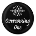 Close-up of circular Noosa snap button featuring Overcoming One text and scroll design - 18mm / Pale Blue