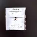 Teacher appreciation wish card bracelet with apple charm in clear plastic packaging - Black