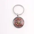 Detailed view of the Nordic Viking Valknut keychain with a glass cabochon pendant. - Golden Valknut / Silver