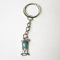 Close-up of vintage silver stainless steel letter I keychain with turquoise stone detail. - Letter I