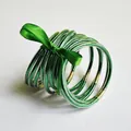 Set of 10 shimmering green glitter jelly bangles decorated with a green ribbon bow - 10 Pieces Pack / Green