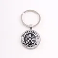 Detail shot of a silver Nordic Viking keychain featuring Valkyries runes and a Vegvisir compass. - VALKYRIES Compass / Silver