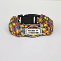 Macro view of Autism Awareness paracord bracelet with puzzle heart and colorful braided cord - AWARENESS