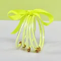 Close-up of five-layer fluorescent yellow glitter jelly bangles with golden lotus charms - 5 Pieces / Neon Yellow