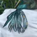 Set of 9 dark green glitter jelly bangles tied with a matching satin ribbon. - 9 Pieces Set / Dark Green