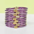 Stack of 10 purple glitter jelly bangles with golden lotus charms for women and girls - 10 Pieces Pack / Purple