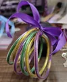 Glittery silicone bangles set in gold, green, and purple with a satin ribbon bow - Set of 6 / Purple, Gold, Green Mix