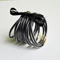 Set van 10 flexibele zwarte PVC jelly armbanden met gouden glitters en lintstrik - Zwart