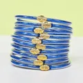 Set di 10 braccialetti jelly blu glitterati in PVC silicone con chiusure a loto dorate - Confezione da 10 / Blu