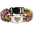 Handmade rainbow paracord bracelet featuring a colorful puzzle heart charm and black buckle - Heart