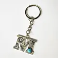 Vintage silver letter M keychain featuring turquoise stone and western engraved motifs - Letter M