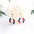 Detail shot of nautical lifebuoy earrings with red, white, and blue enamel patterns. - Lifebuoy Shape