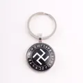 Nordic Viking Elder Futhark rune keychain featuring a central white sun wheel symbol - Runic Swastika Symbol / Silver