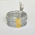 Detailed view of six silver glitter silicone bangles featuring gold wire wrap and a ribbon - Silver