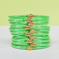 Set di bracciali jelly verdi glitterati con chiusure a loto dorate - Confezione da 10 / Verde erba