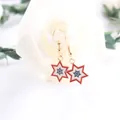 Close-up of USA flag-inspired star dangle earrings with red white and blue enamel - Hexagonal Star Style
