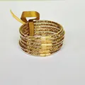 Detail view of 6-layer gold glitter silicone bracelets with a decorative ribbon bow. - Rose Gold