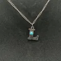 Vintage silver-tone initial necklace featuring a turquoise-embedded letter L pendant - Letter L