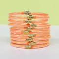 Set di dieci bracciali jelly arancioni glitterati con ciondoli a forma di fiore di loto dorati - Confezione da 10 / Arancione