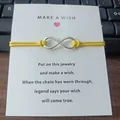 Handmade infinity charm bracelet with yellow cord on a Make a Wish message card - Infinity Symbol (EB0168) / Yellow